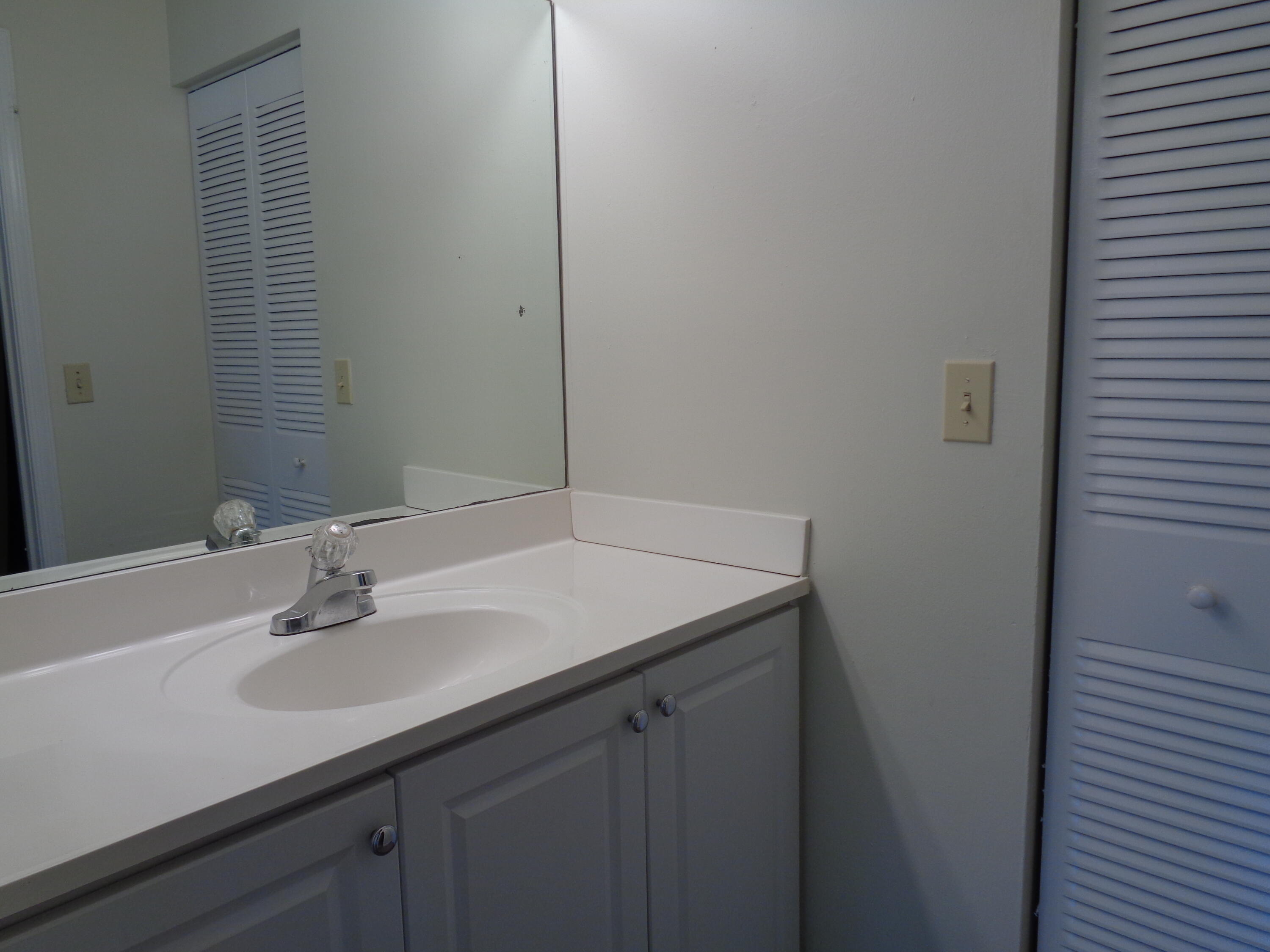 301 Olivewood Place, Unit O227 Boca Raton, FL 33431 - Photo 12 of 20 a bathroom with a sink and a mirror