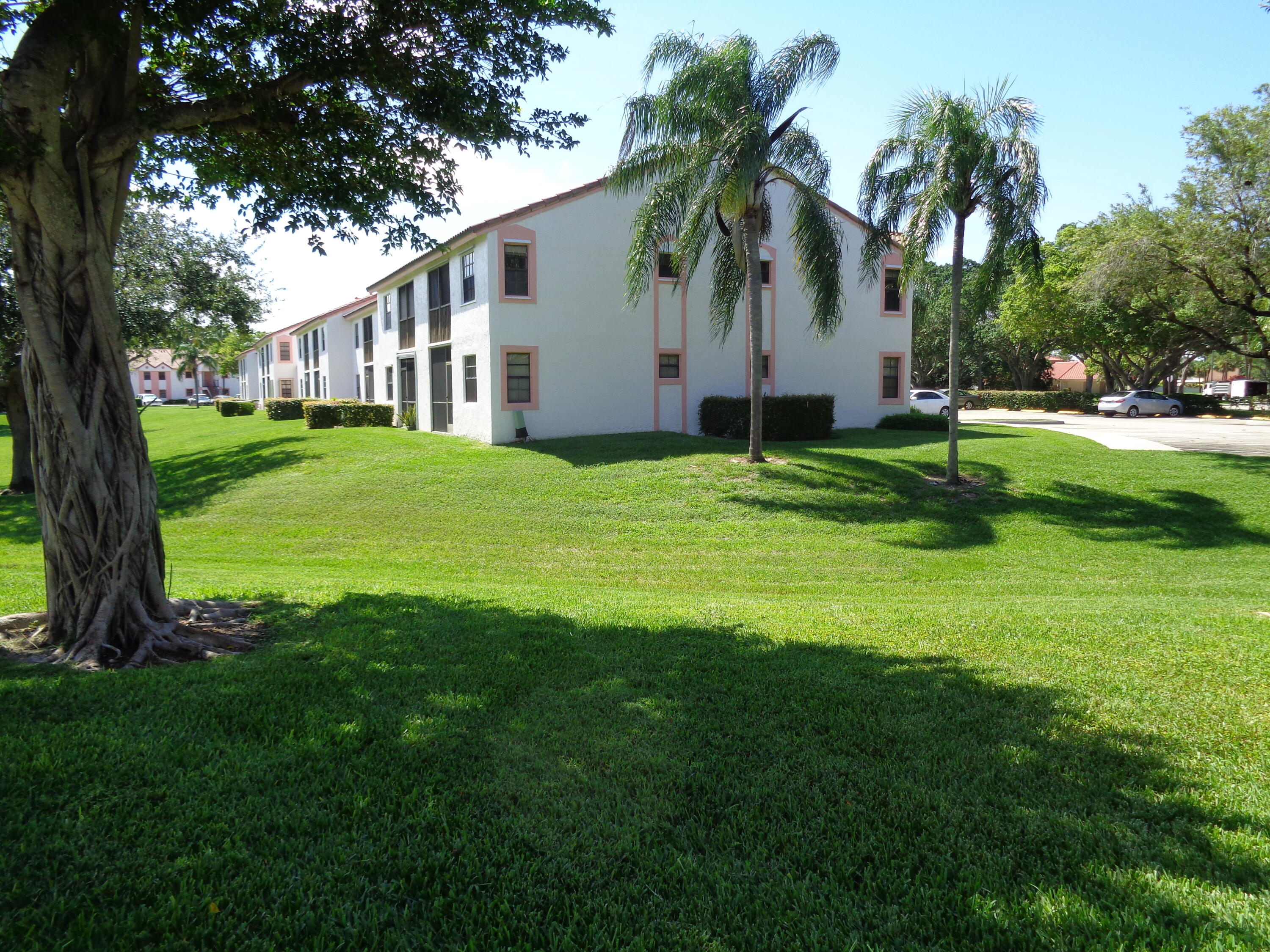 301 Olivewood Place, Unit O227 Boca Raton, FL 33431 - Photo 4 of 20 a front view of house with yard and green space