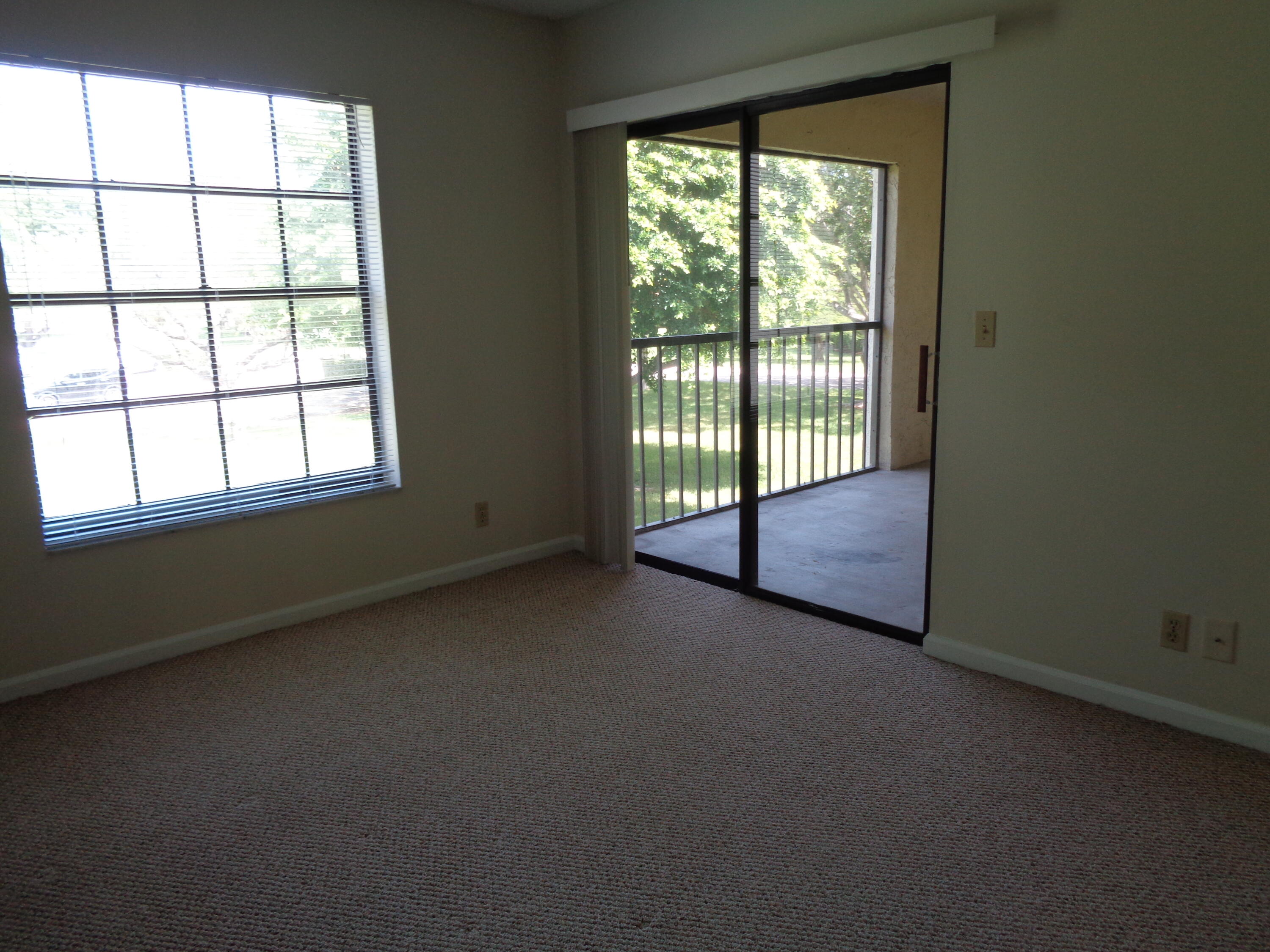 301 Olivewood Place, Unit O227 Boca Raton, FL 33431 - Photo 9 of 20 an empty room with windows
