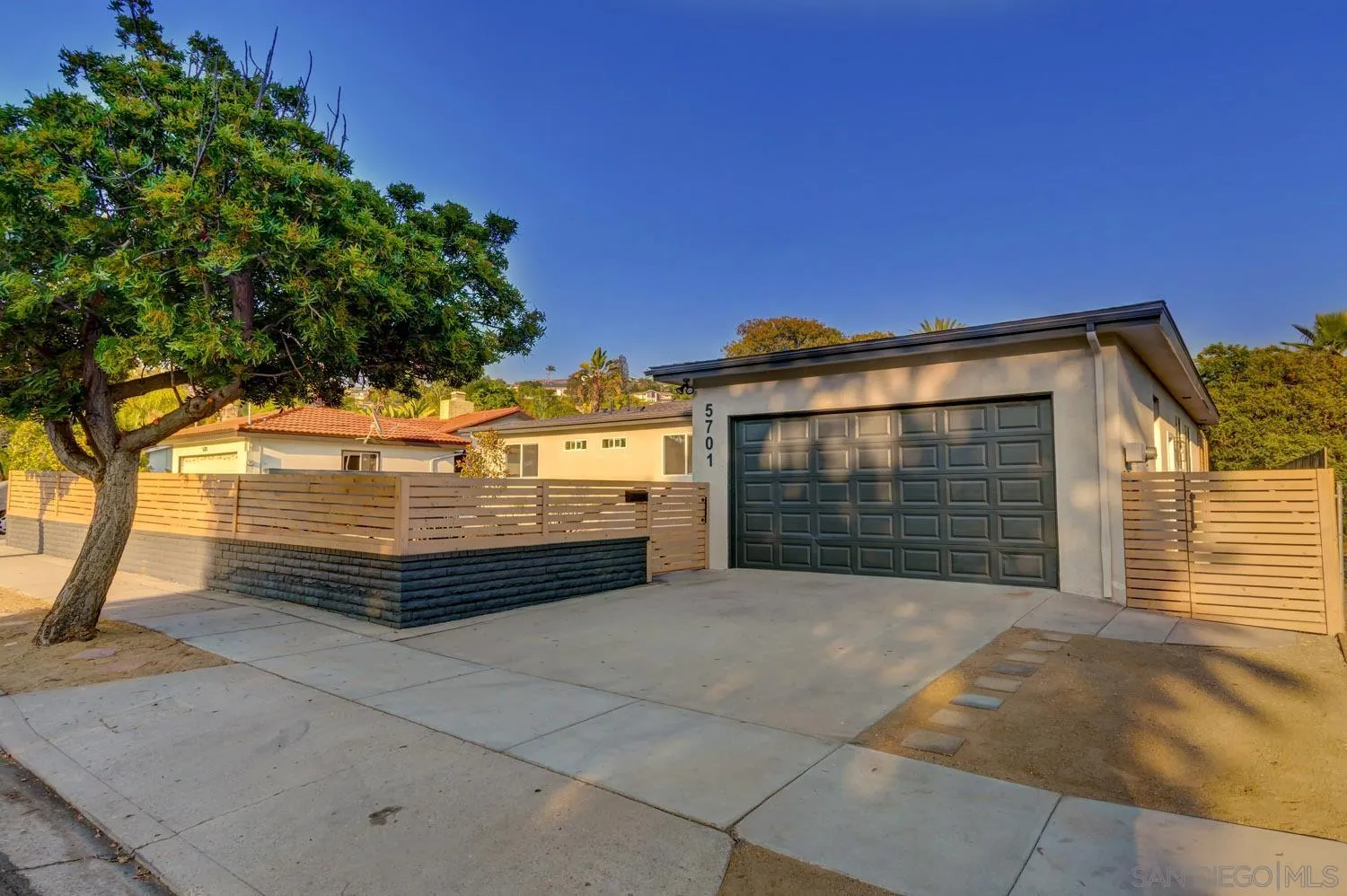 5701 Madra Avenue San Diego, CA 92120 - Photo 15 of 15 a view of a house with a yard