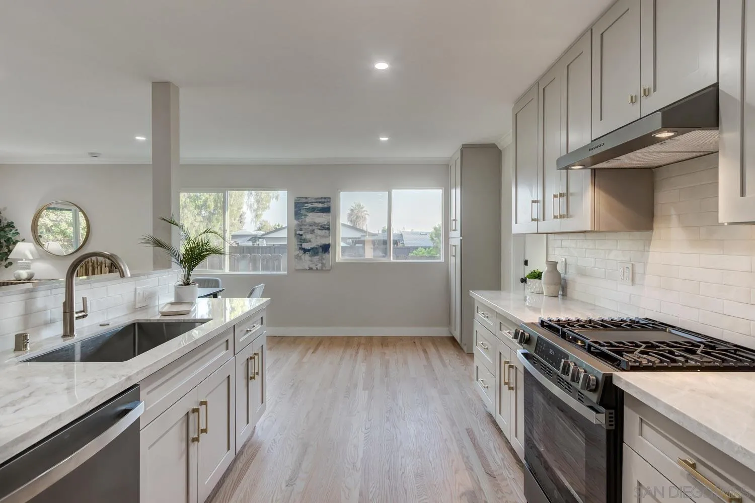 5701 Madra Avenue San Diego, CA 92120 - Photo 5 of 15 a kitchen with stainless steel appliances granite countertop a sink stove and refrigerator