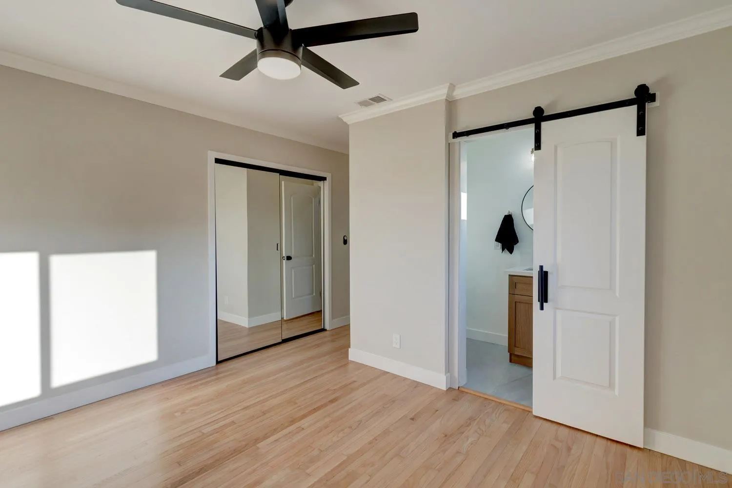 5701 Madra Avenue San Diego, CA 92120 - Photo 8 of 15 a view of empty room with wooden floor and closet