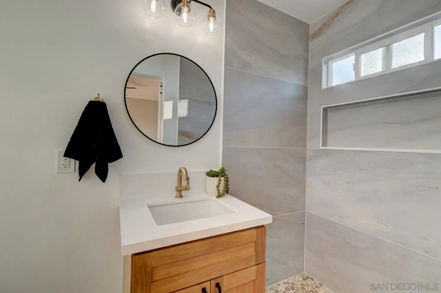 5701 Madra Avenue San Diego, CA 92120 - Photo 9 of 15 a bathroom with a sink and a mirror