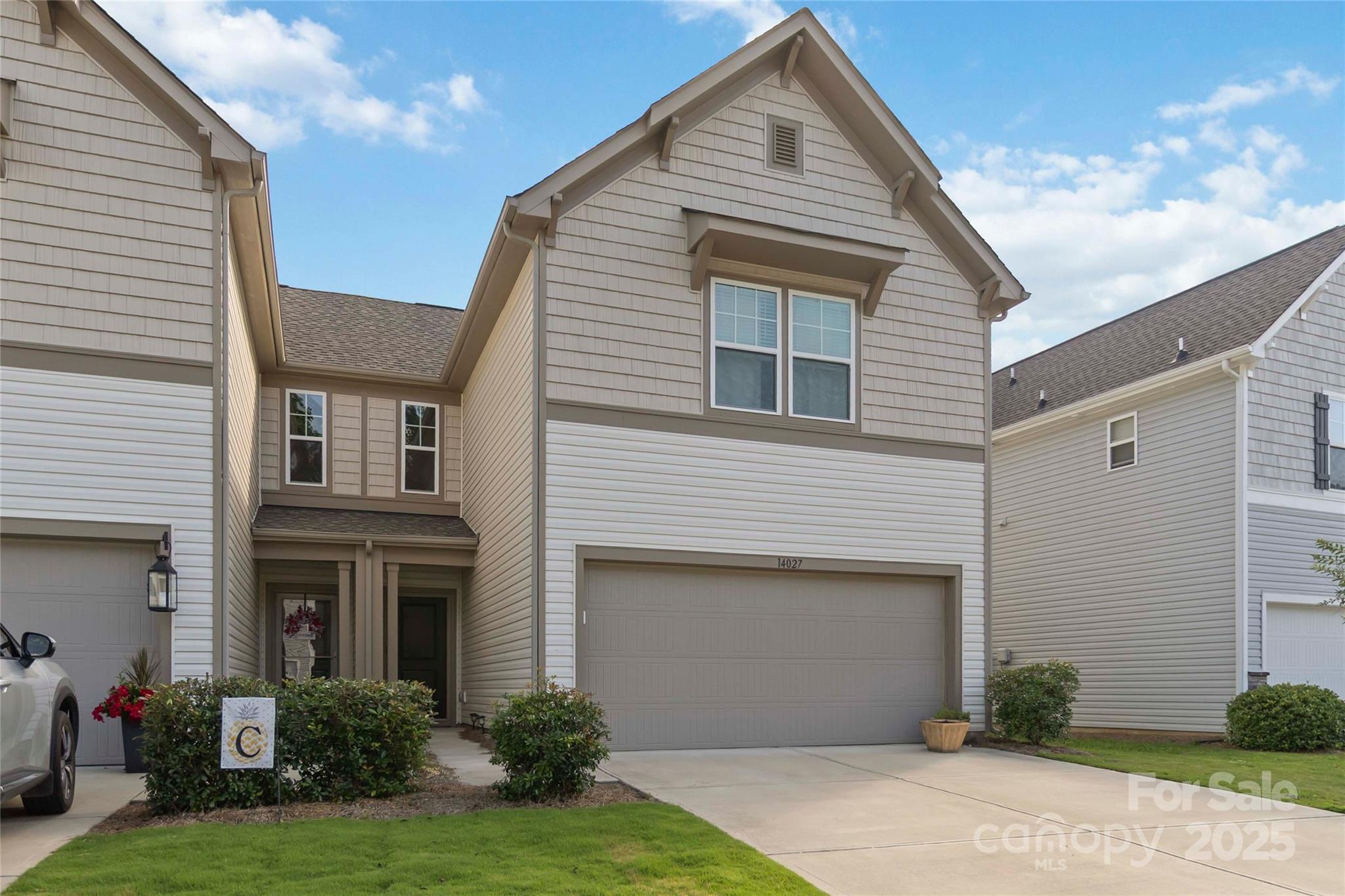 a view of a white house next to a yard
