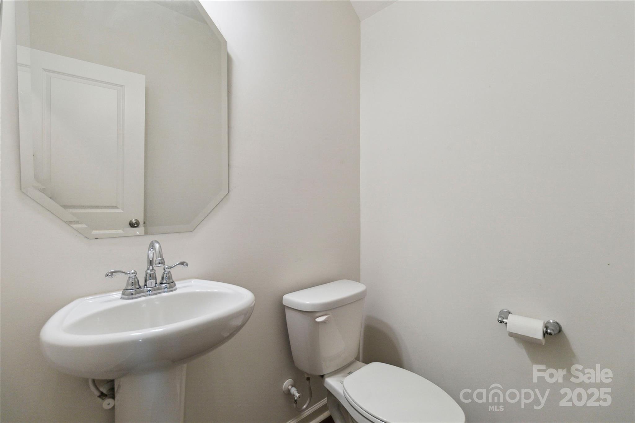14027 Clayborn Street Midland, NC 28107 - Photo 16 of 35 a bathroom with a sink a toilet and mirror