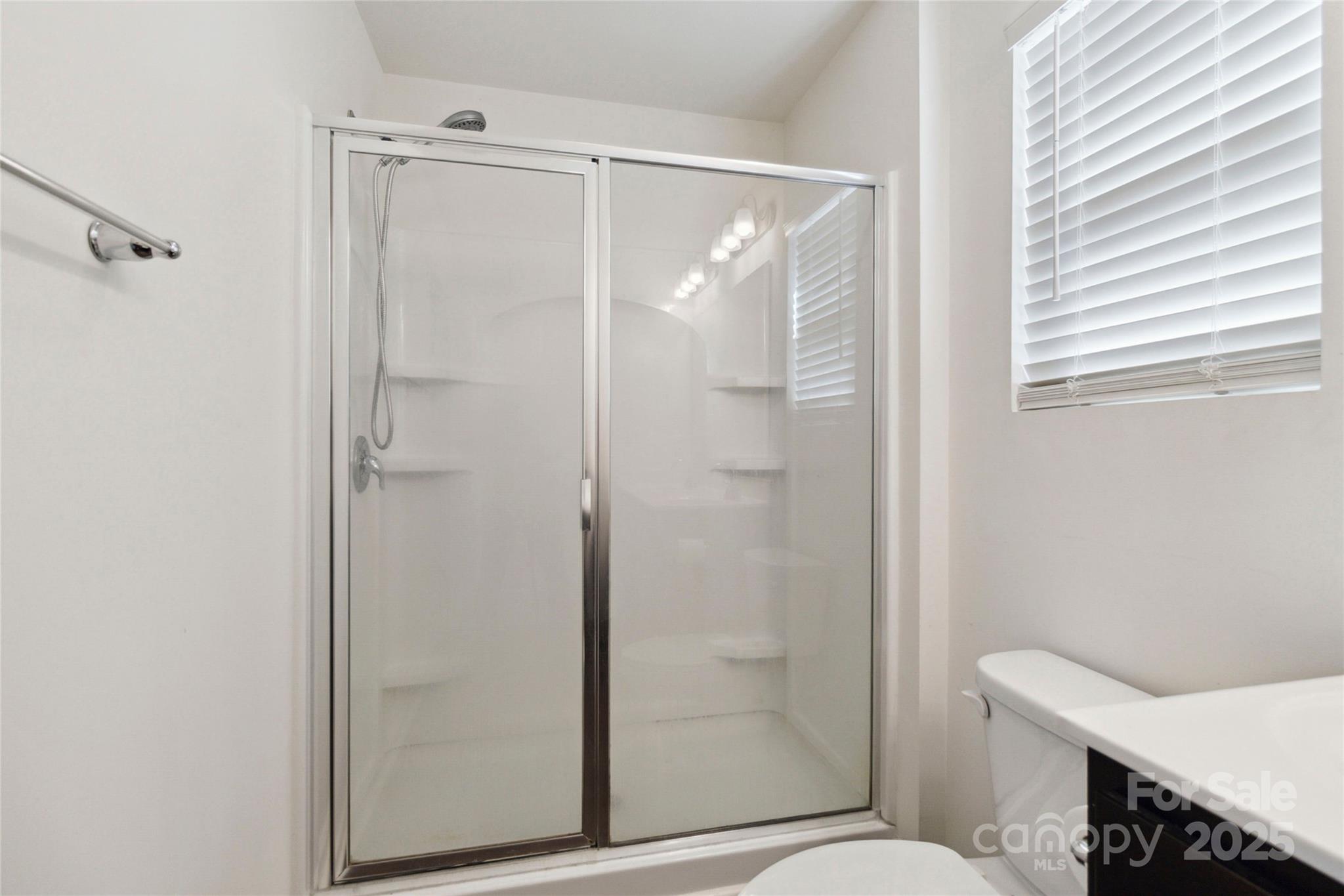 14027 Clayborn Street Midland, NC 28107 - Photo 23 of 35 a bathroom with a shower and a toilet