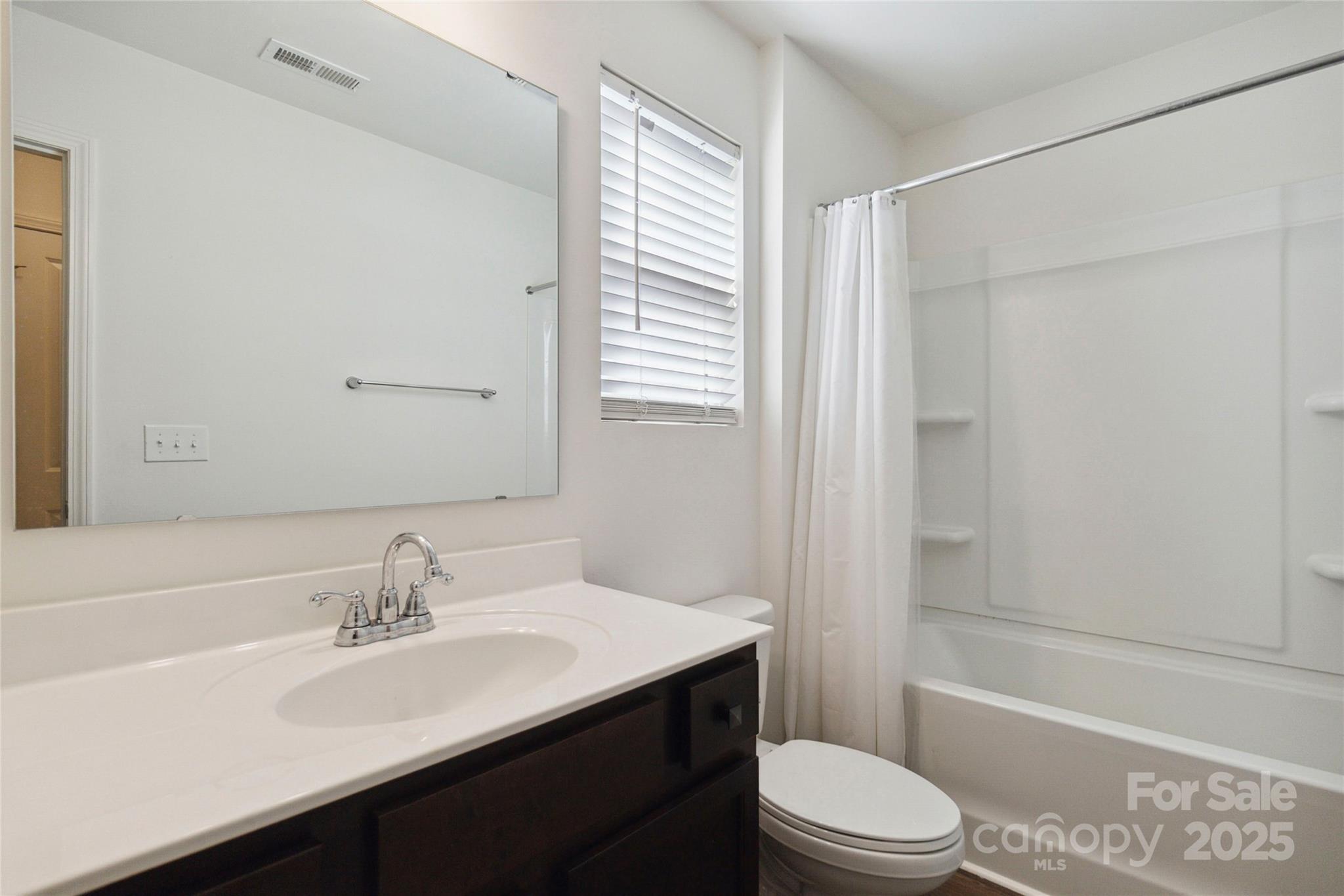 14027 Clayborn Street Midland, NC 28107 - Photo 25 of 35 a bathroom with a sink a toilet and shower