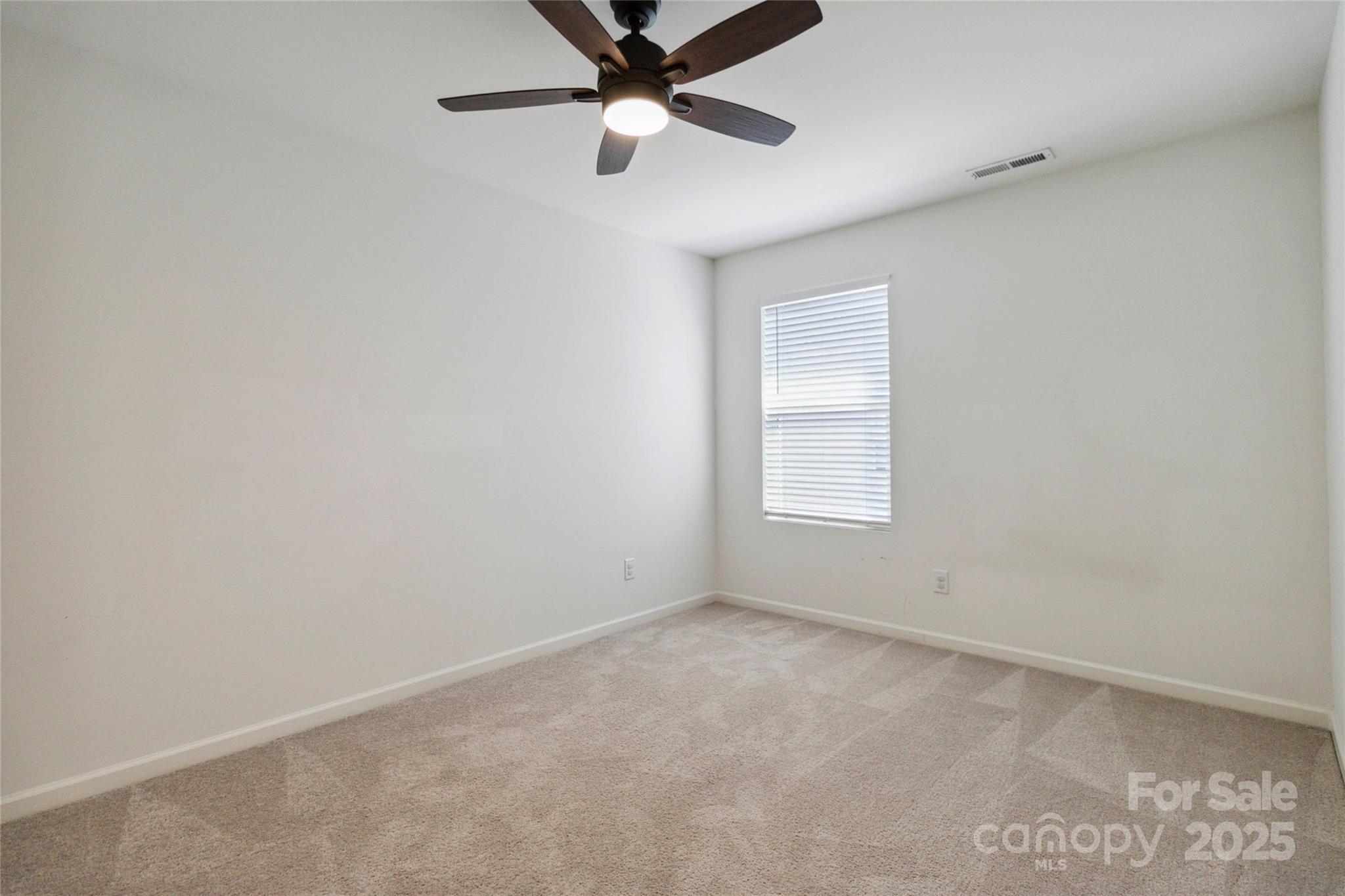 14027 Clayborn Street Midland, NC 28107 - Photo 28 of 35 an empty room with a window and a fan