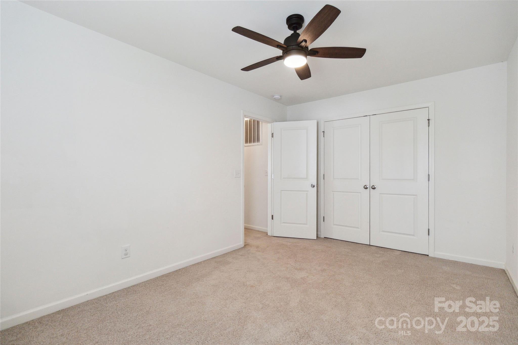 14027 Clayborn Street Midland, NC 28107 - Photo 29 of 35 an empty room with a ceiling fan