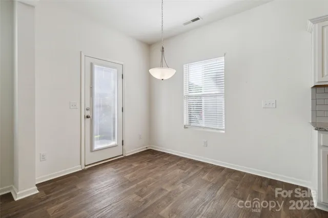 a kitchen with kitchen island granite countertop a refrigerator oven a stove top oven a sink and dishwasher