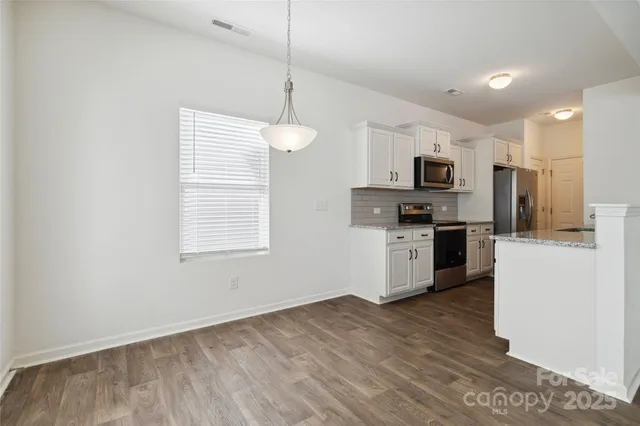 a kitchen with stainless steel appliances granite countertop a stove and a sink