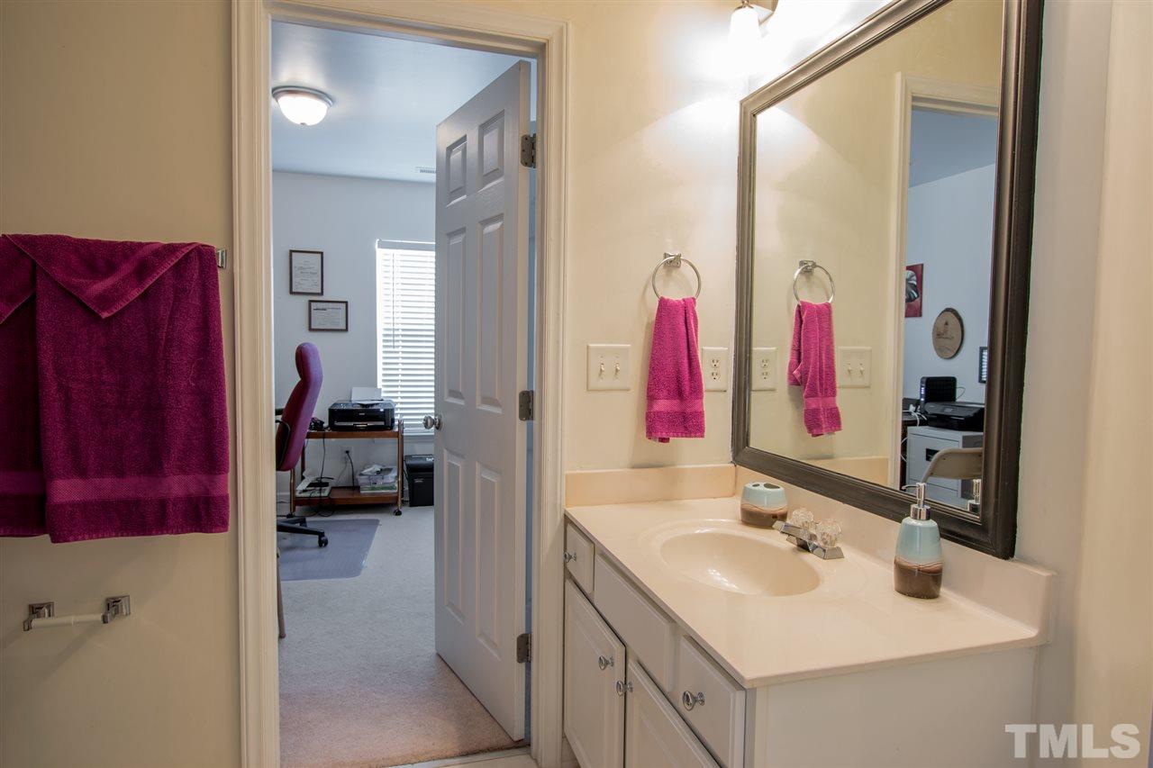 8412 Aztec Dawn Court Raleigh, NC 27613 - Photo 20 of 24 a bathroom with a sink vanity and a mirror
