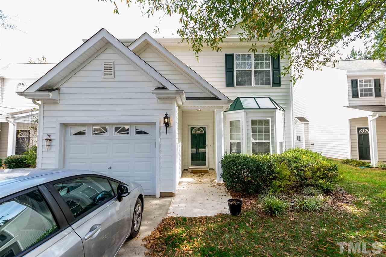 8412 Aztec Dawn Court Raleigh, NC 27613 - Photo 2 of 24 a front view of a house with a garden