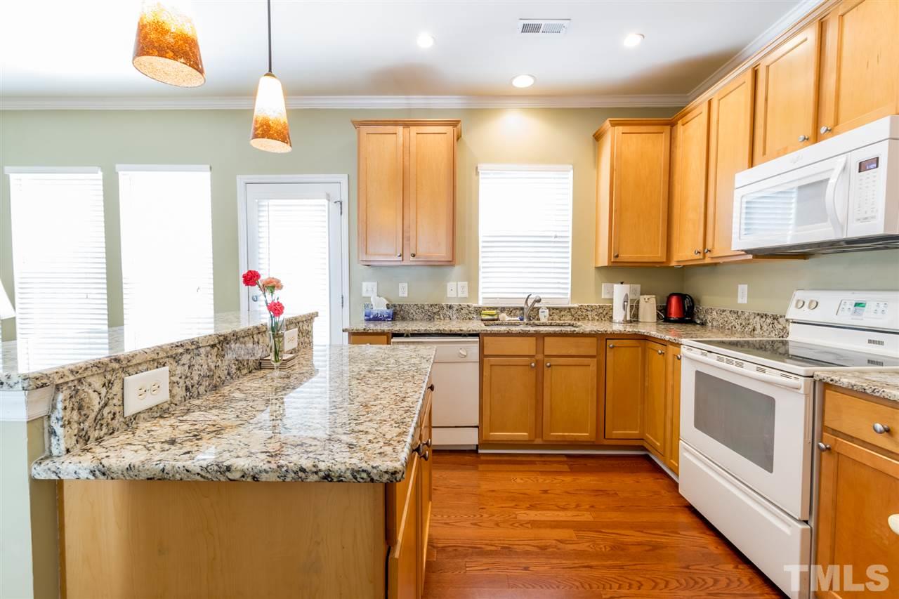 8412 Aztec Dawn Court Raleigh, NC 27613 - Photo 6 of 24 a kitchen with granite countertop sink and cabinets