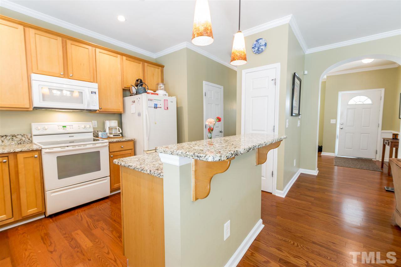 8412 Aztec Dawn Court Raleigh, NC 27613 - Photo 8 of 24 a kitchen with a stove and white cabinets