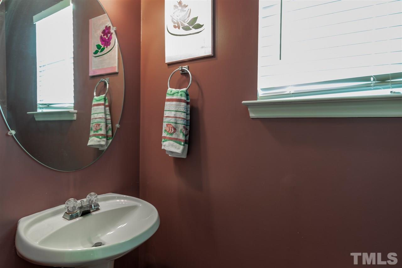 8412 Aztec Dawn Court Raleigh, NC 27613 - Photo 9 of 24 a bathroom with a sink and a mirror