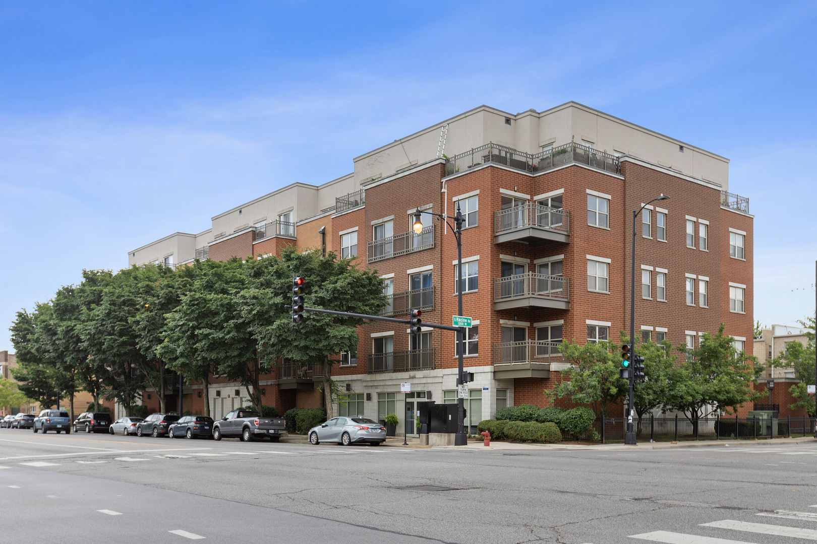 1155 West Roosevelt Road, Unit 402 Chicago, IL 60608 - Photo 1 of 1 a view of a building and car parked on the side of road