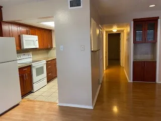 a view of a kitchen cabinets and a wooden floor