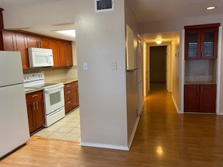 2401 Leon Street, Unit 203 Austin, TX 78705 - Photo 15 of 22 a view of a kitchen cabinets and a wooden floor