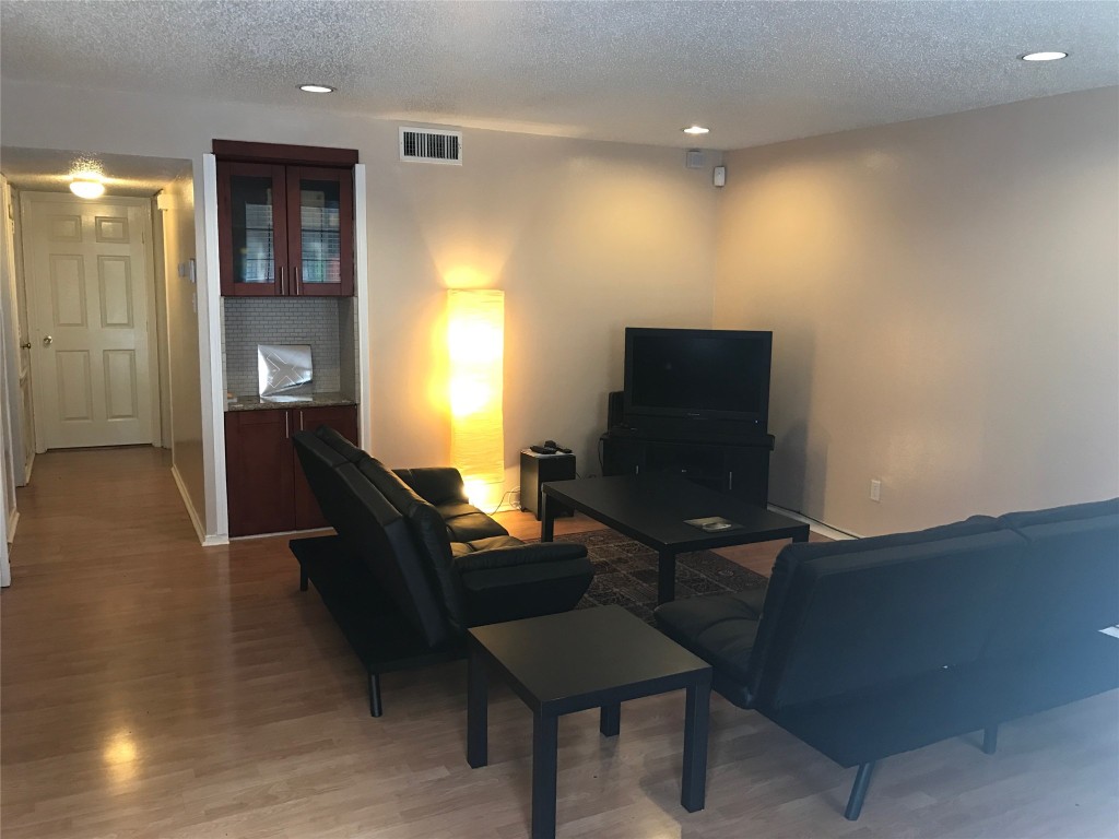2401 Leon Street, Unit 203 Austin, TX 78705 - Photo 17 of 22 a living room with furniture and a flat screen tv