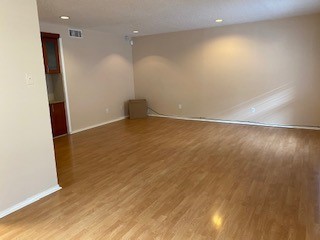 2401 Leon Street, Unit 203 Austin, TX 78705 - Photo 20 of 22 an empty room with wooden floor and entrance