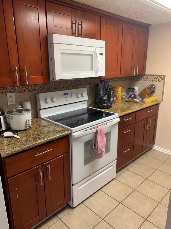 2401 Leon Street, Unit 203 Austin, TX 78705 - Photo 4 of 22 a kitchen with granite countertop a stove sink and cabinets