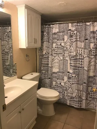 a bathroom with a toilet sink and shower
