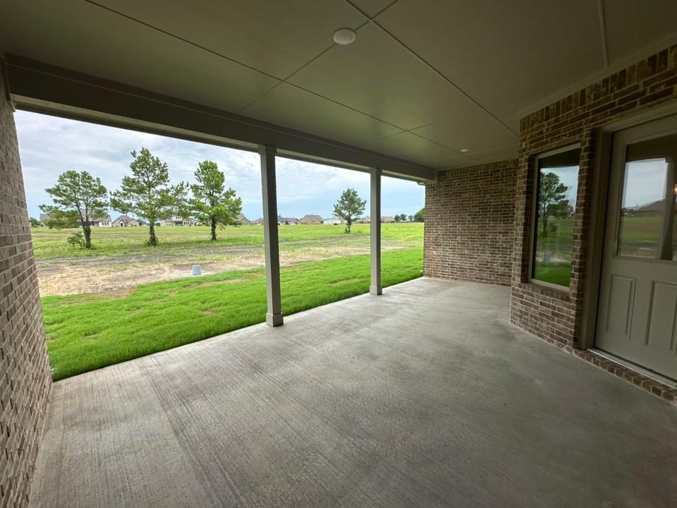410 Cobb Road Leonard, TX 75452 - Photo 23 of 24 Covered patio featuring a concrete slab and brick exterior wall