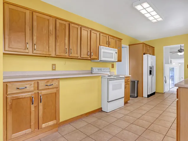 a kitchen with a refrigerator sink and cabinets