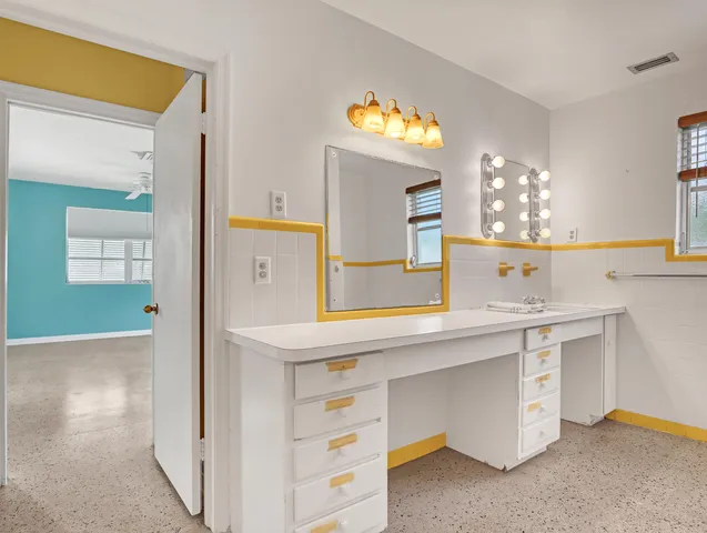 a spacious bathroom with a sink a large mirror and a shower