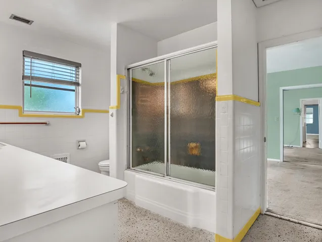 a bathroom with a tub and a shower