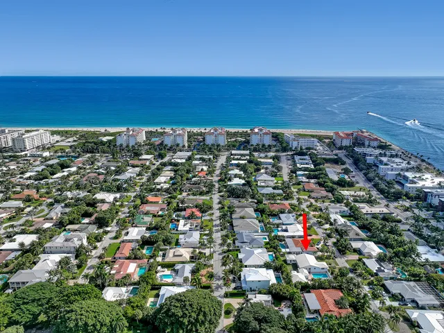 an aerial view of a city with lots of residential buildings lake and ocean view
