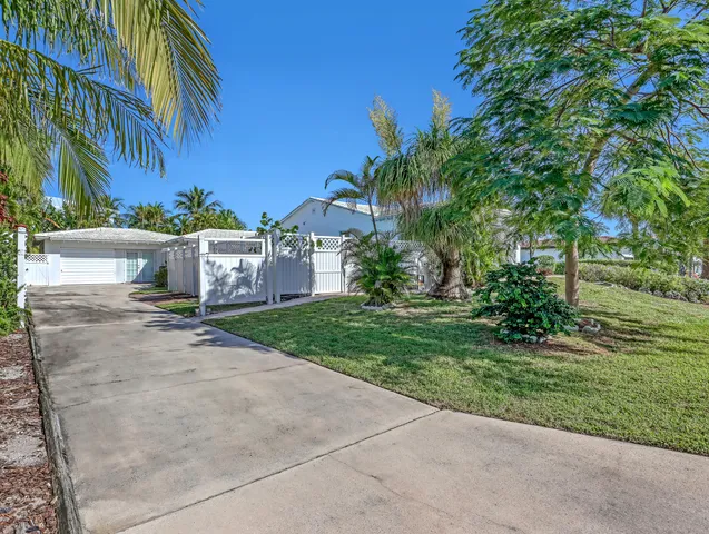 a front view of a house with a yard and a garage