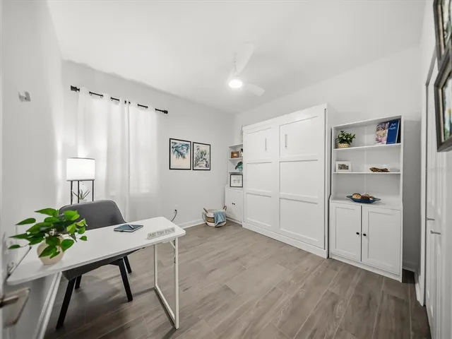 a living room with furniture a table and large window
