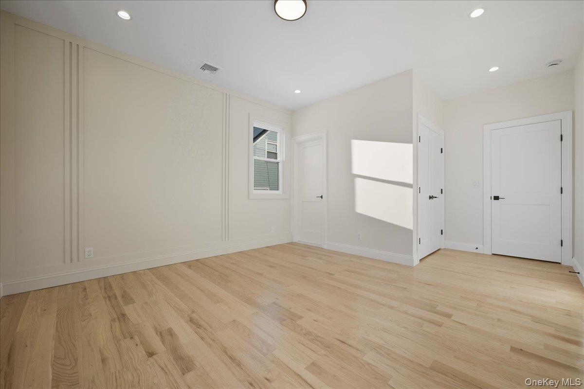 3 Bentley Road Plainview, NY 11803 - Photo 22 of 41 wooden floor in an empty room with a window