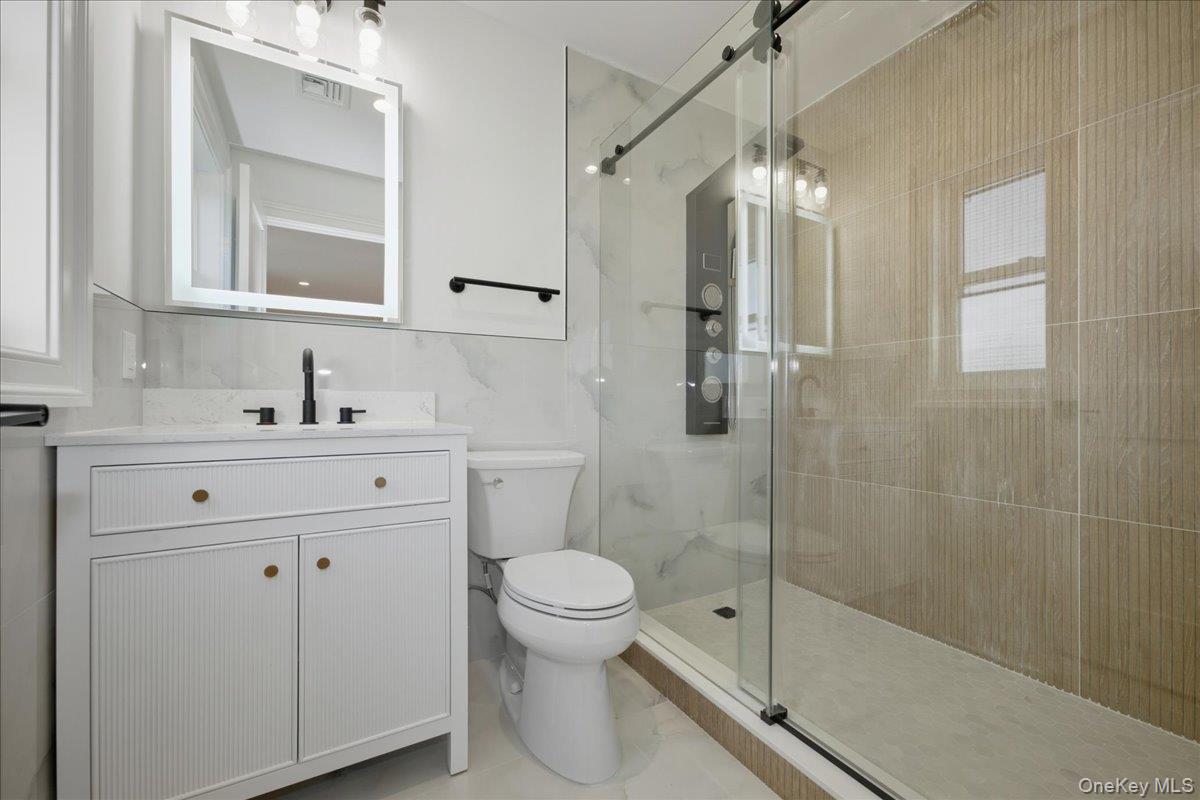 3 Bentley Road Plainview, NY 11803 - Photo 34 of 41 a bathroom with a sink a toilet and shower