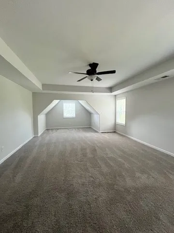 a view of empty room with ceiling fan