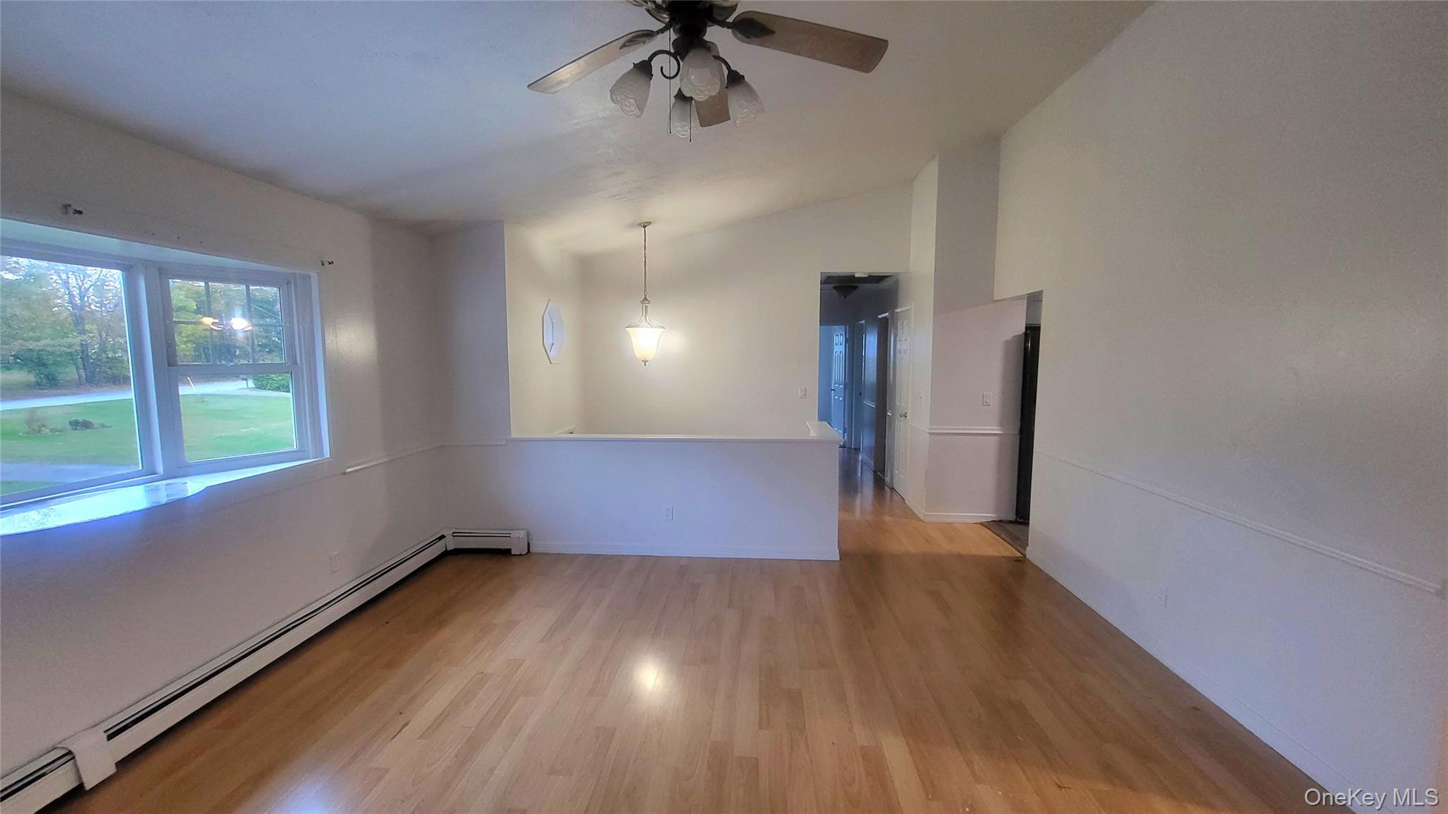 11 Pleasant Lane Poughkeepsie, NY 12603 - Photo 5 of 12 wooden floor in an empty room with a window