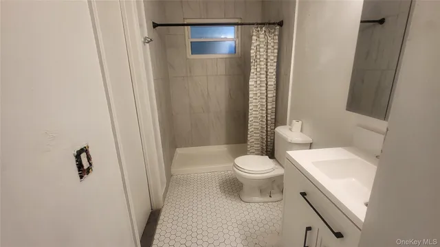a white toilet sitting next to a bathroom sink