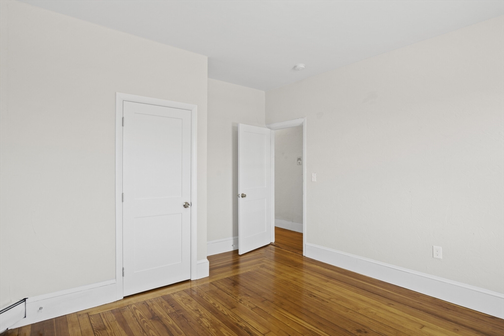 10 Redfield Street, Unit 2 Boston, MA 02122 - Photo 4 of 10 a view of an empty room with wooden floor