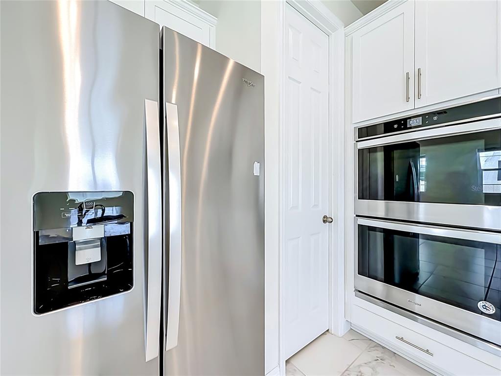 16822 Wingspread Loop Winter Garden, FL 34787 - Photo 14 of 47 a kitchen with stainless steel appliances a refrigerator and cabinets