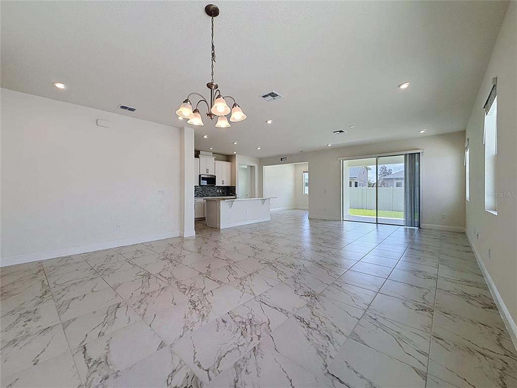 16822 Wingspread Loop Winter Garden, FL 34787 - Photo 20 of 47 a view of a kitchen with a sink and a chandelier