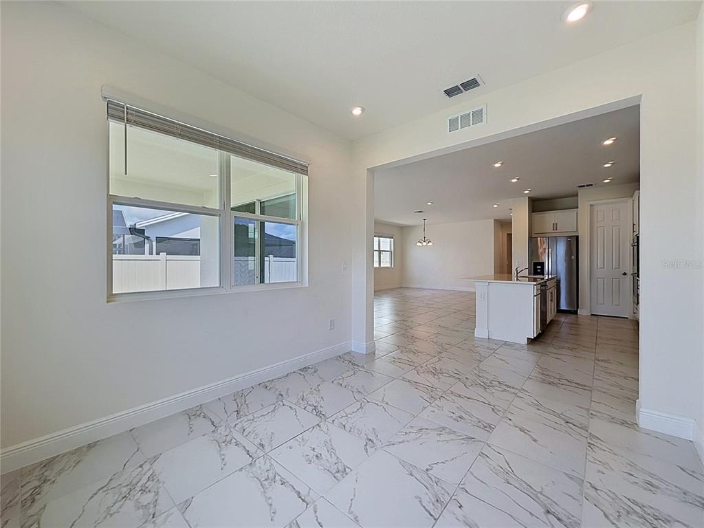 16822 Wingspread Loop Winter Garden, FL 34787 - Photo 23 of 47 a view of a big room with windows and chandelier