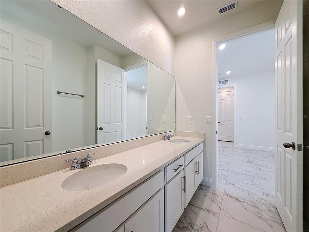 16822 Wingspread Loop Winter Garden, FL 34787 - Photo 25 of 47 a bathroom with a double vanity sink mirror and double