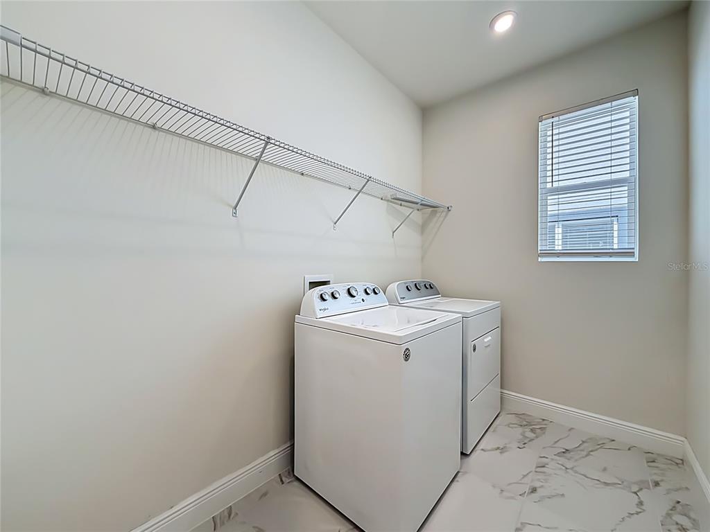 16822 Wingspread Loop Winter Garden, FL 34787 - Photo 35 of 47 a utility room with dryer and washer