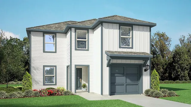 a front view of a house with a garden and plants