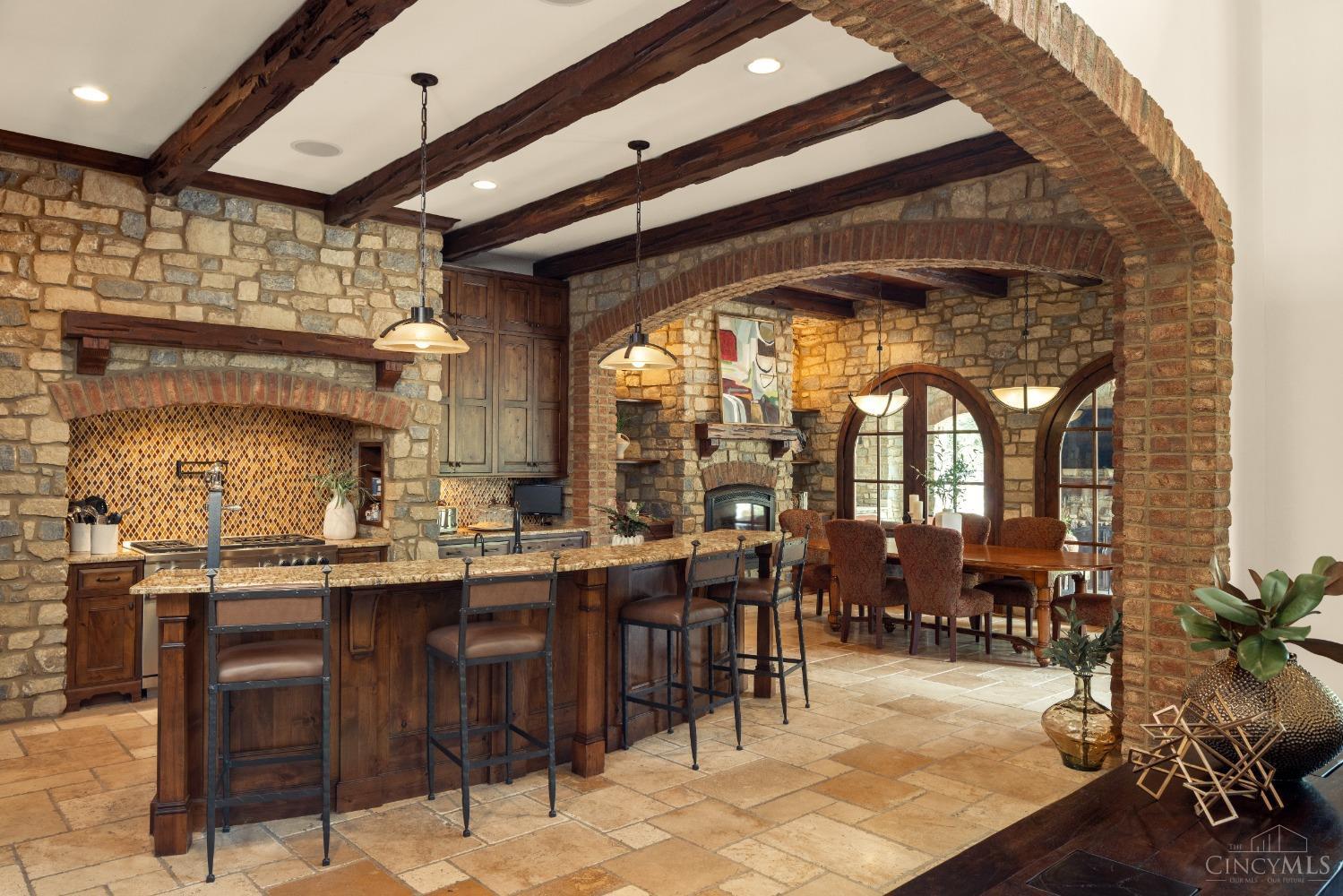 5900 Park Road Cincinnati, OH 45243 - Photo 11 of 50 Gourmet Kitchen (19’ X 18’) This elegant kitchen is large and inviting! Features include an arched brick entryway, limestone flooring, tiered granite counter bar, beam ceiling, and seamless flow into breakfast room.