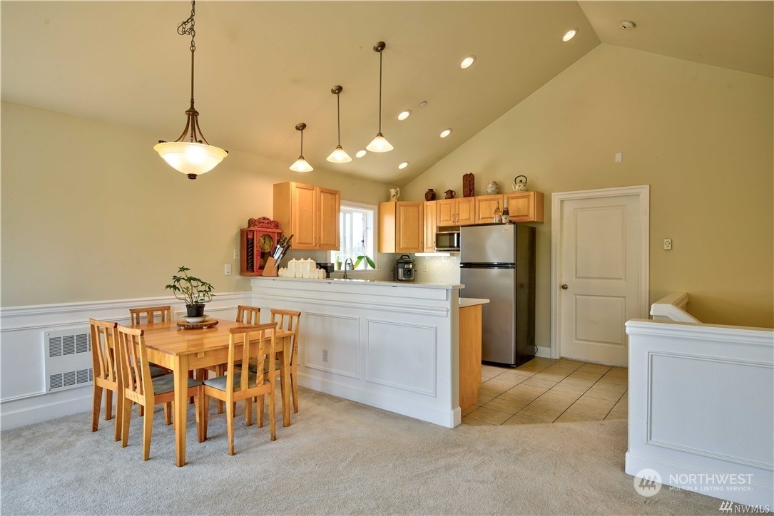 3315 Rockefeller Avenue, Unit 4 Everett, WA 98201 - Photo 16 of 29 a view of a dining room with furniture and a chandelier