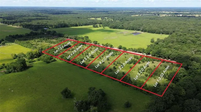 an aerial view of a golf course with a lake view