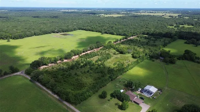an aerial view of a golf course with parking space